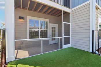 Screened patio with artificial turf and covered access